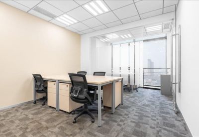 Bright four-person private office suite with grey carpet and large window.