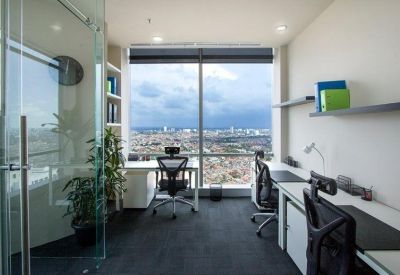 Two-person private office with floor-to-ceiling windows overlooking the city skyline.