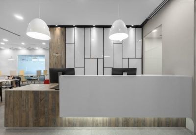 Bright communal kitchen and break area with white cabinetry and breakfast bar.