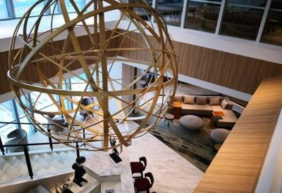 High-angle view of a lobby area featuring a large geometric gold light fixture.