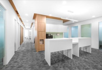 Wide hallway area with a coffee station and sleek white cabinetry.