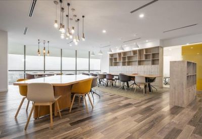 Vibrant communal breakout area with wooden floors and stylish pendant lighting.