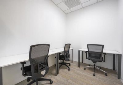 Bright, white three-person office suite with ergonomic chairs.