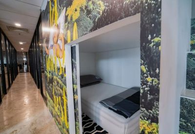 Modern hallway featuring a cozy built-in sleeping pod with floral wallpaper.