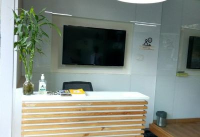 Minimalist reception desk with a wood-slat design, a monitor, and a yellow dome light.