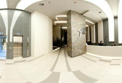 Spacious modern lobby with a stone feature wall and sleek reception desk.