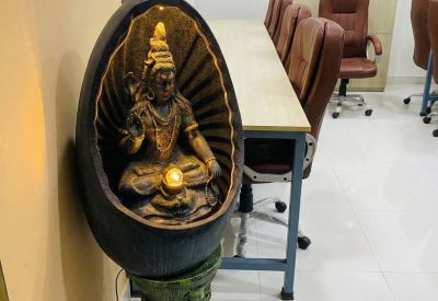 Decorative indoor water fountain featuring a seated deity statue.