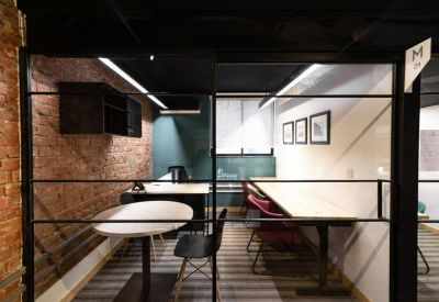 Private office suite with a brick feature wall and glass partitioning.