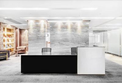 Professional reception desk with a sleek black front and marble background.