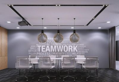 Professional meeting room featuring a teamwork-themed wall mural.