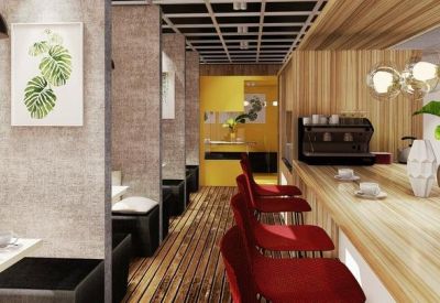 Cozy cafe-style seating area with red chairs and wooden accents.