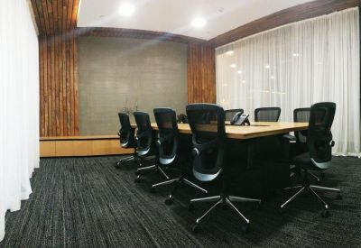Large conference room with black mesh chairs and wood-paneled walls.