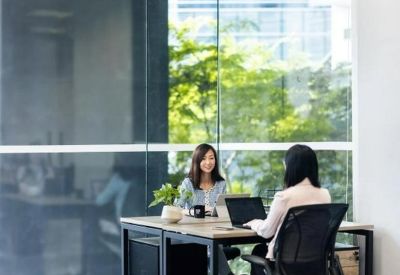 Open-plan workspace with natural light from floor-to-ceiling windows.