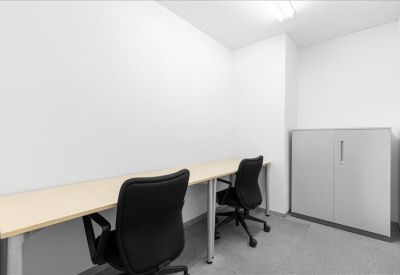 Quiet two-person internal office suite with a long desk and storage cabinet.