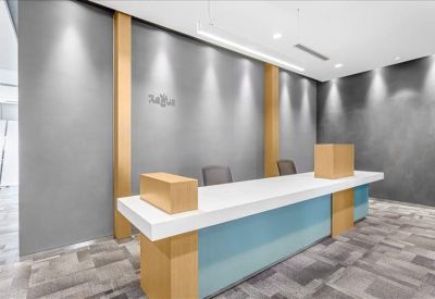 Modern reception desk with blue accents and warm vertical wood panels.