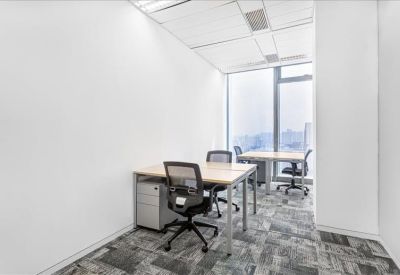 Bright private office with two desks and a view through a large window.