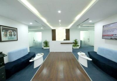 Modern reception area with a minimalist white desk and blue velvet seating.