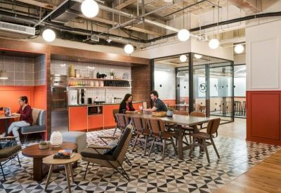 Modern kitchen and dining area with orange cabinetry, patterned tile flooring, and globe pendant lights.