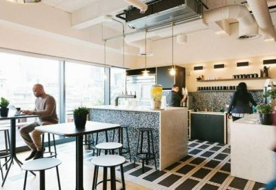 Kitchen and dining area with marble-patterned island and a coffee station.
