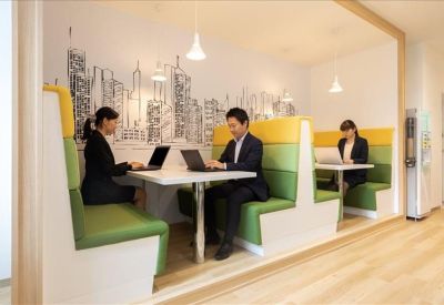 Breakout area with built-in booth seating and city skyline wall mural.