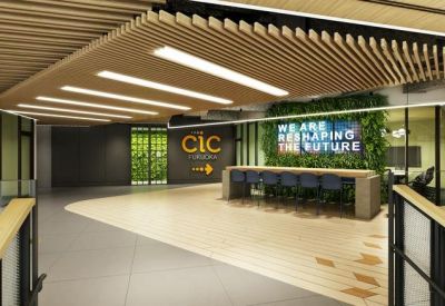 Reception area with a wooden slat ceiling, green plant wall, and branded signage.