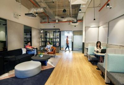 Coworking space featuring high-back booths and informal lounge seating.
