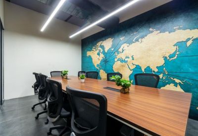 Modern conference room featuring a large world map mural and wooden table.