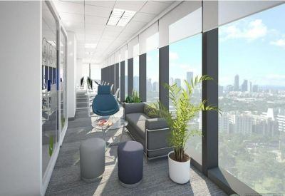 Lounge area with gray sofa, blue armchair, and large windows overlooking the city.