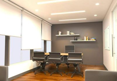Professional meeting room with a wooden table, grey ergonomic chairs, and wall shelving.