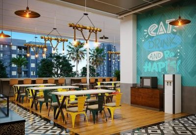 Bright dining area with colorful chairs and large windows looking out to palm trees.