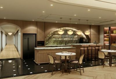 Sleek office cafe and bar area with marble counters and wood paneling.