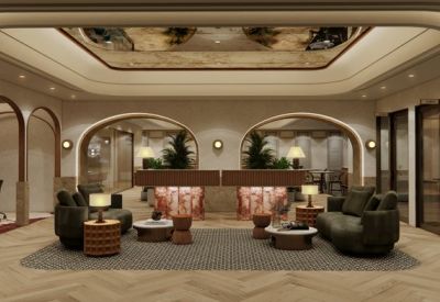 Luxury reception area with curved ceiling, warm lighting, and plush seating.