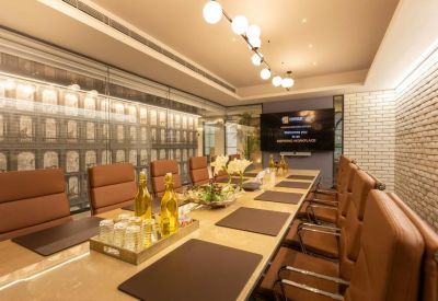 Sophisticated boardroom with leather chairs, long wooden table, and warm lighting.