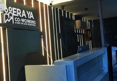 Modern reception desk with vertical wood slatting and branded signage.