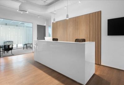Sleek white reception desk with a vertical wood-slat feature wall.