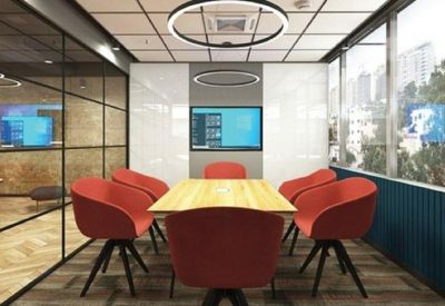Modern meeting room featuring bright red chairs around a wooden table and a large window view.
