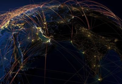 Digital graphic of a glowing global network at night over the Earth.