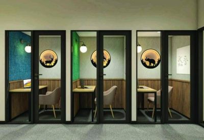 Private glass-fronted focus booths with wooden desks and animal-themed wall art.