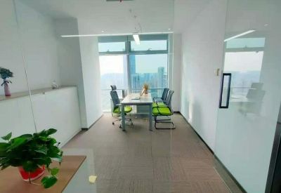 Private office for four people with bright green chairs and panoramic city views.