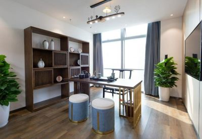 Tea room featuring a dark wood shelving unit, blue velvet stools, and potted plants.