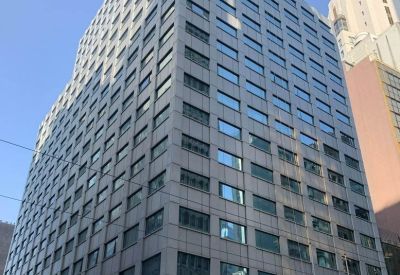 Street-level view of the China Insurance Group Bldg facade featuring bank signage.