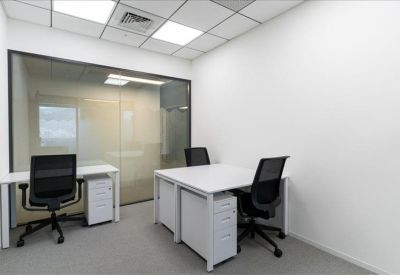 Private two-person office suite with white desks and a glass partition wall.
