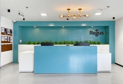Minimalist reception desk in bright blue and white under warm designer lighting.