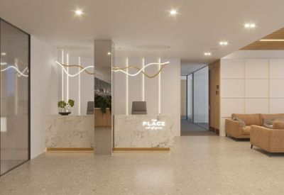 Bright reception area with a marble front desk and stylish pendant lighting.