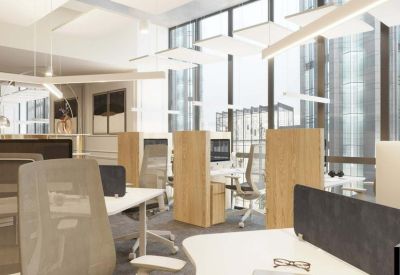 Professional open-plan office with white desks and ergonomic grey chairs.
