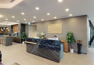 Modern lobby area featuring a marble front desk and a pantry in the background.