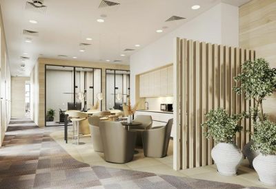 Breakout area with curved leather seating, wood-slat partitions, and a modern kitchenette.