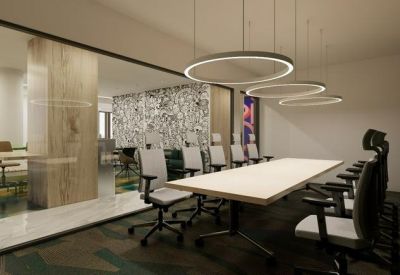 Modern conference room with a long white table, ergonomic chairs, and circular pendant lighting.
