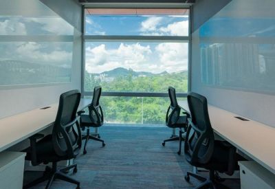 Private office suite with two workstations facing a scenic mountain view.