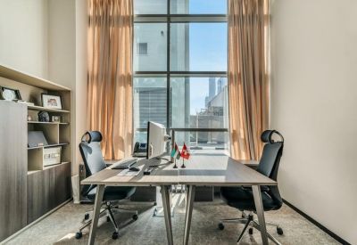 Symmetrical two-person office with a large window and floor-to-ceiling curtains.